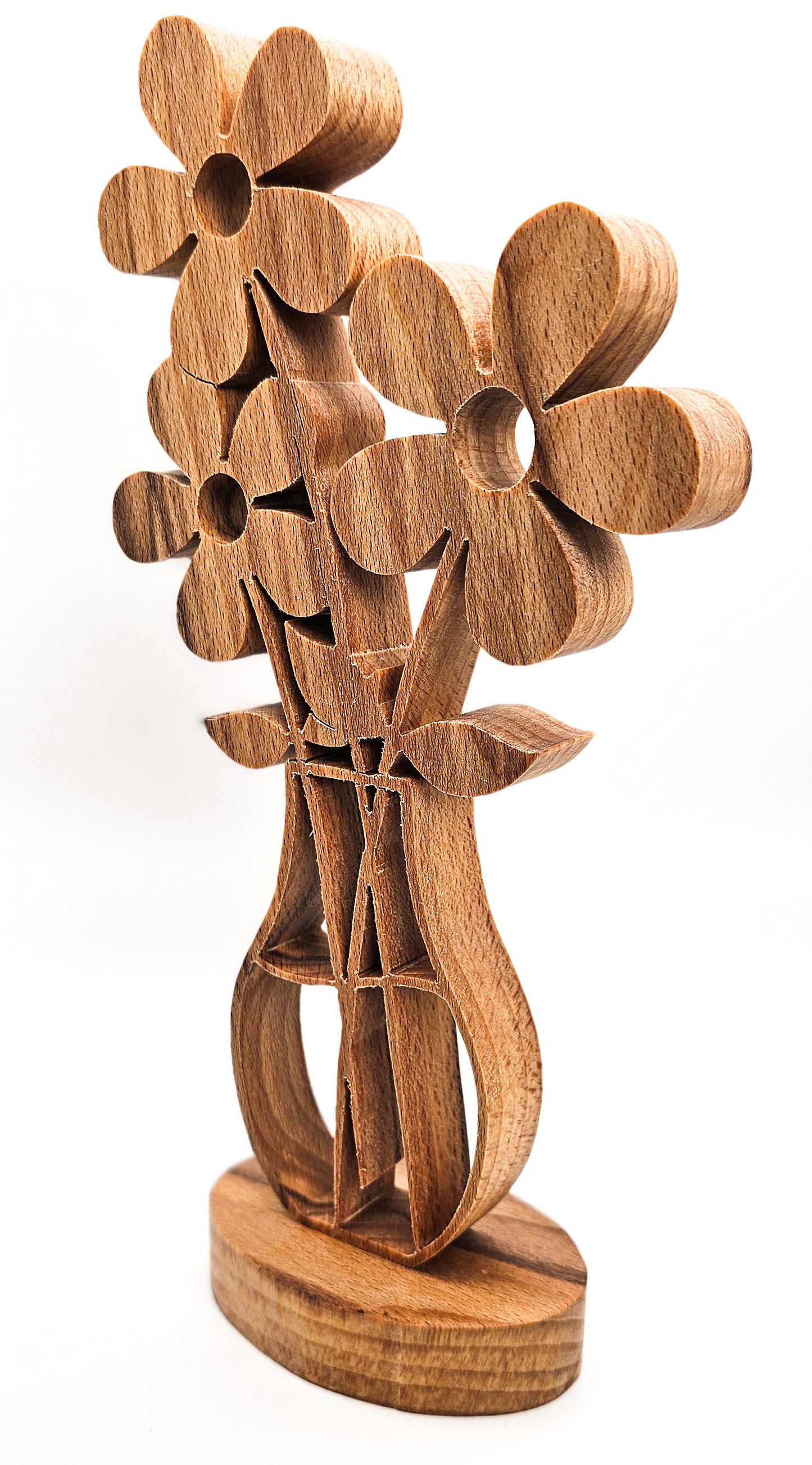 A wooden sculpture of stylized flowers with a vase-like base, crafted from medium brown wood with visible grain, set against a plain white background.