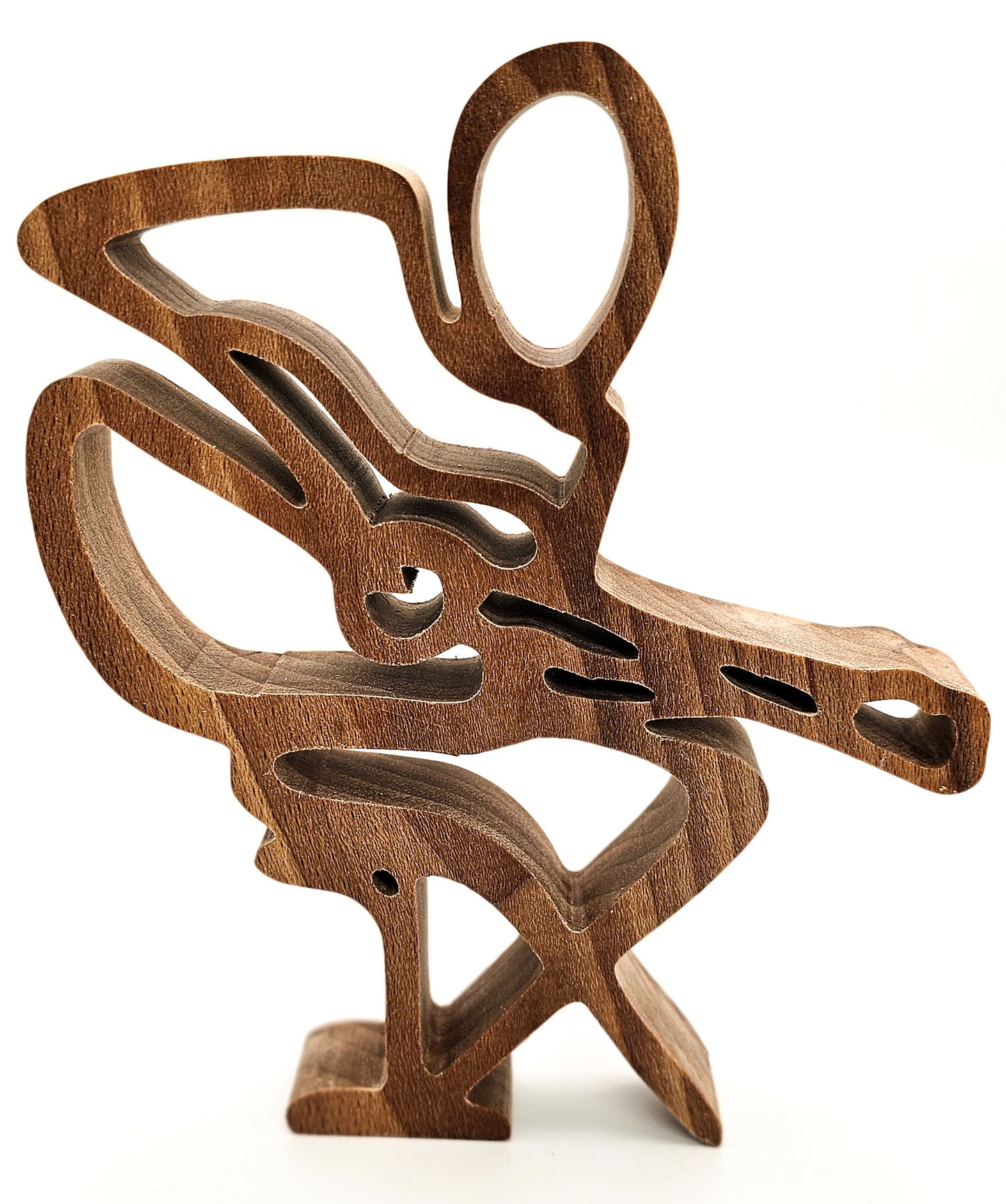 A sculptural wooden decorative object with an abstract guitar player design, photographed on a plain white background.