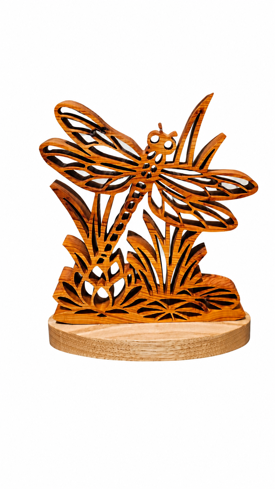 A Handcrafted wooden dragonfly and reeds sculpture on a round natural wood base, shown against a plain white background.