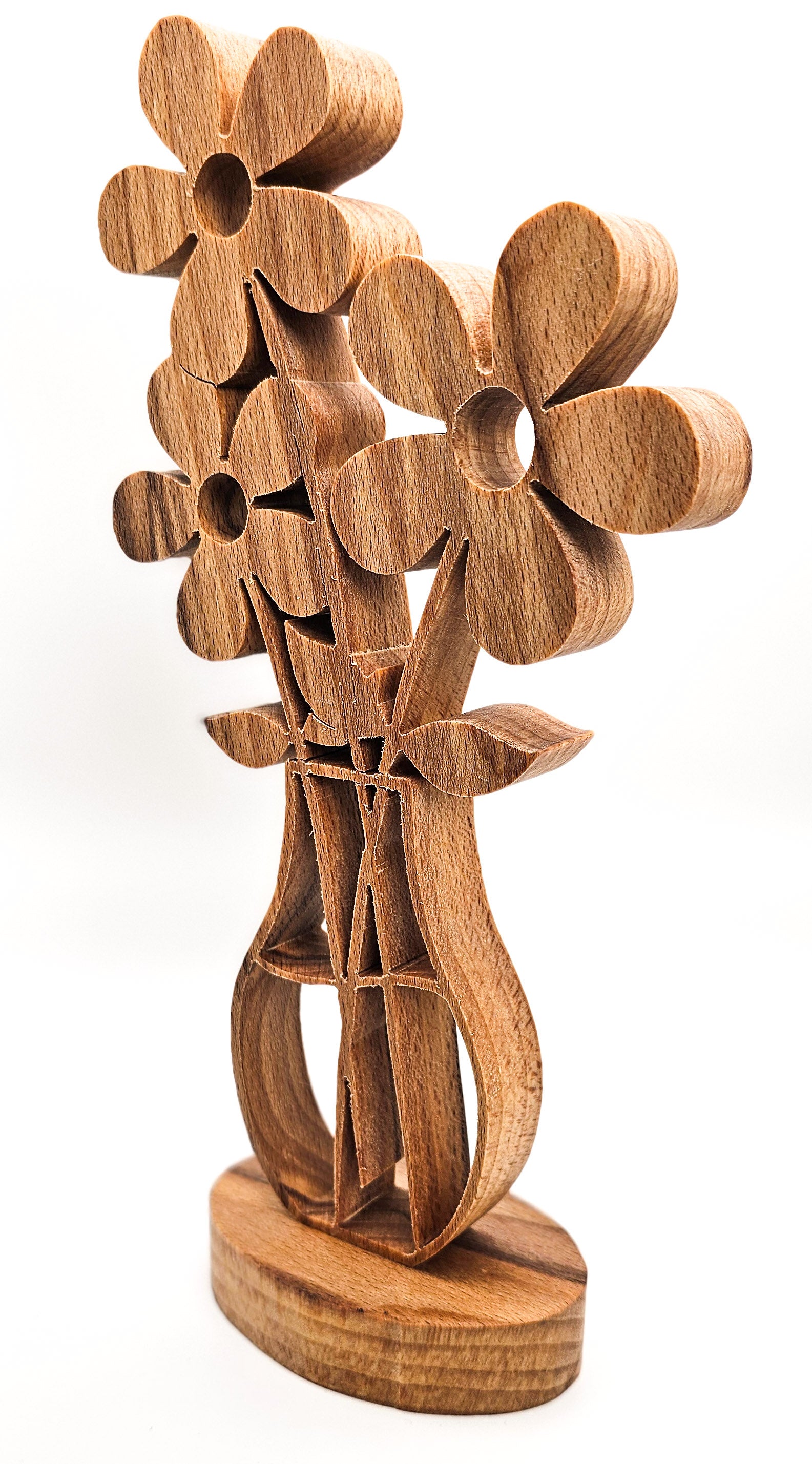 A wooden sculpture of stylized flowers with a vase-like base, crafted from medium brown wood with visible grain, set against a plain white background.