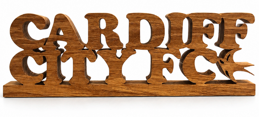 A wooden Handcrafted sign spelling 'CARDIFF CITY FC' with Swallow silhouette in the letter cuts, shown on a plain white background.