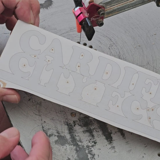 Cutting a Cardiff City sign with a scroll saw
