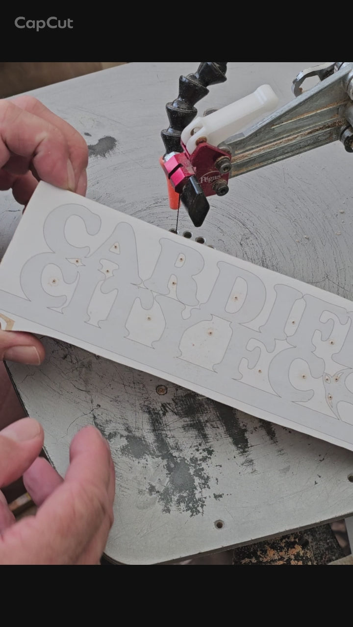 Cutting a Cardiff City sign with a scroll saw